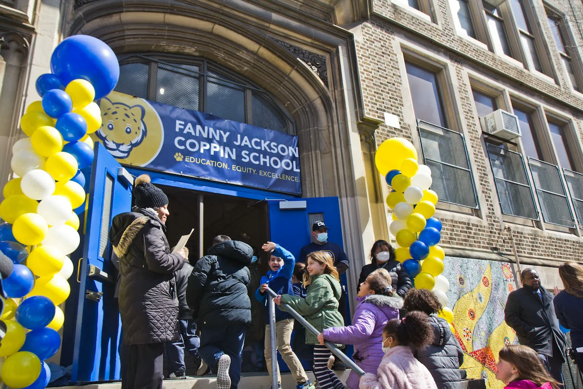 Students and staff at a ribbon-cutting event outside Fanny Jackson Coppin Elementary School