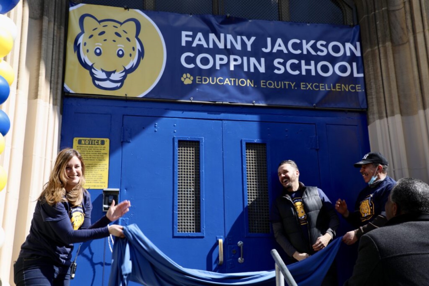 Staff unveiling the Fanny Jackson Coppin School banner